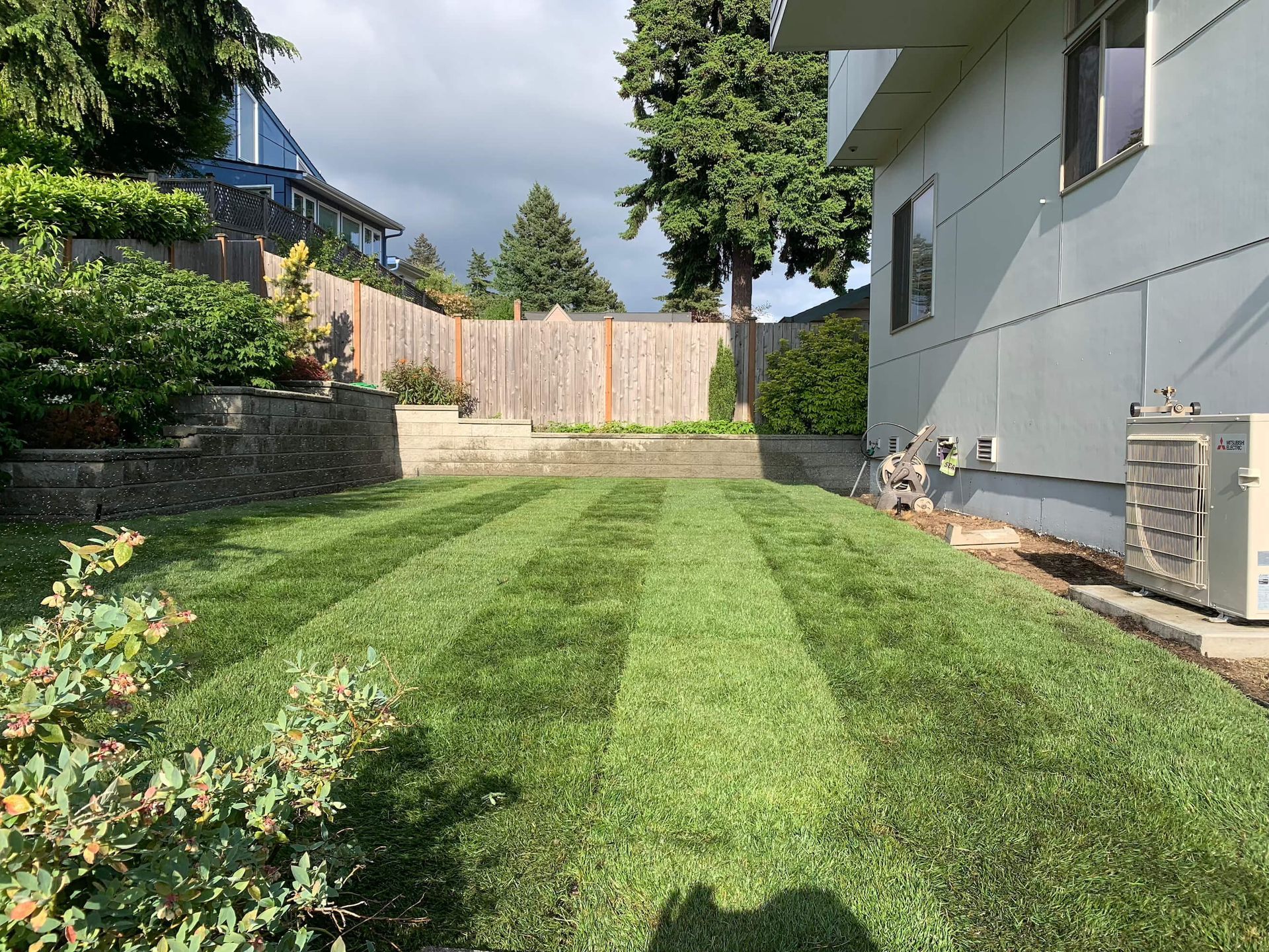 A house with a lush green lawn in front of it.