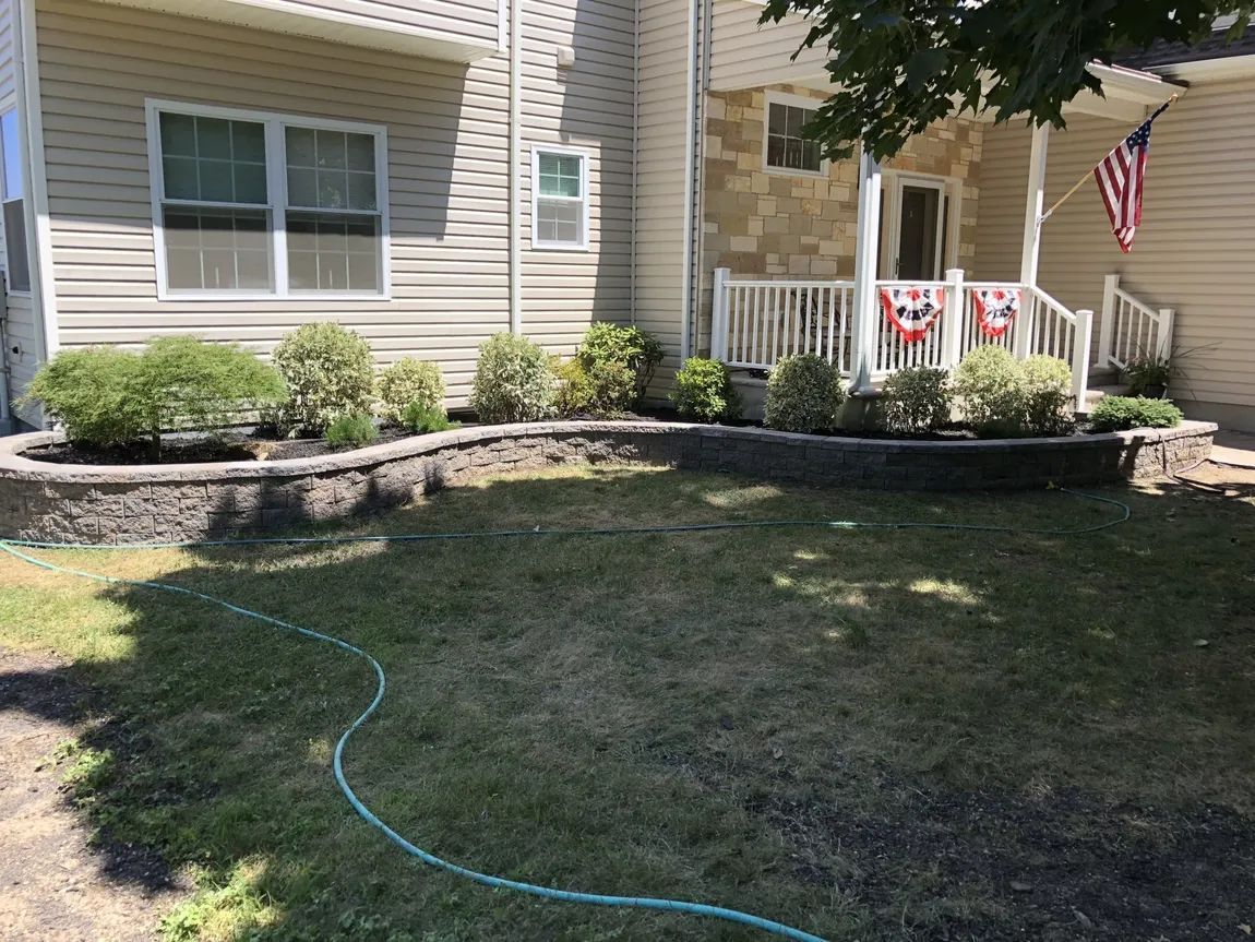 A house with a hose in front of it and a flag on the porch.