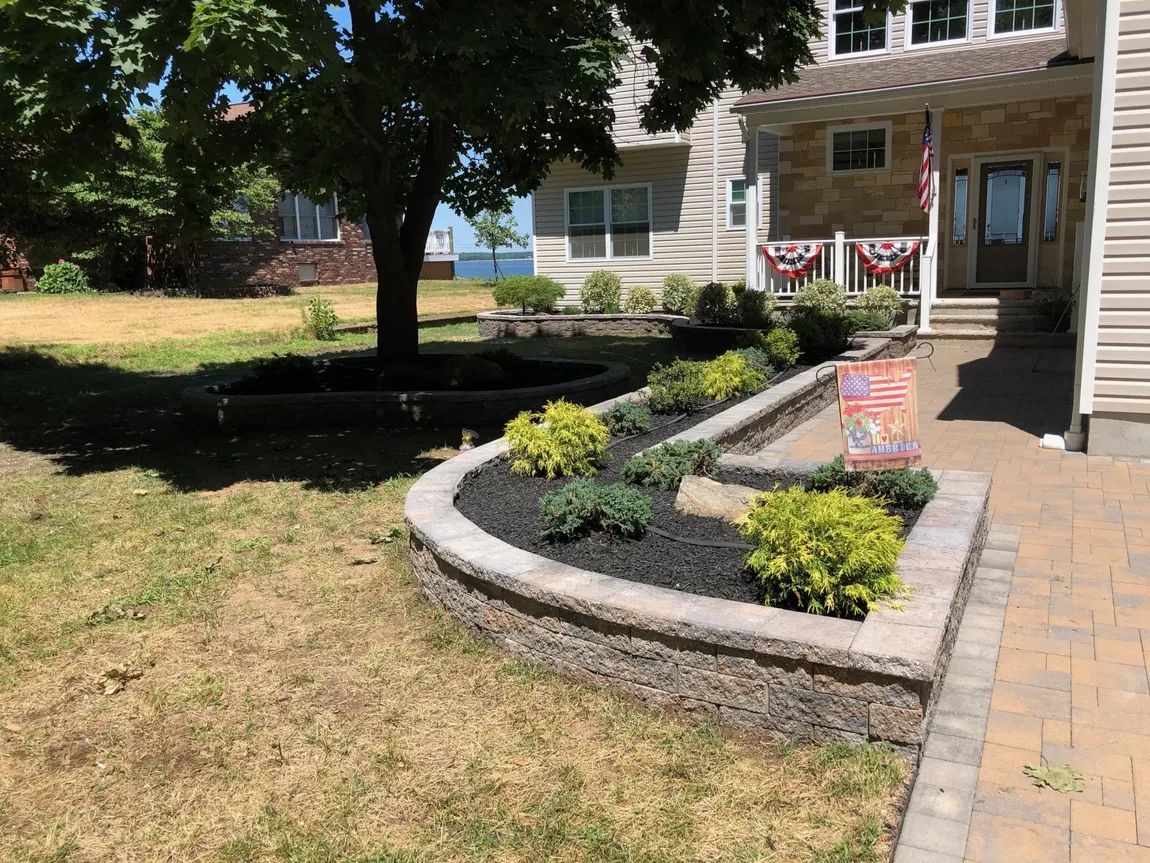 A large house with a lush green lawn and a brick walkway in front of it.