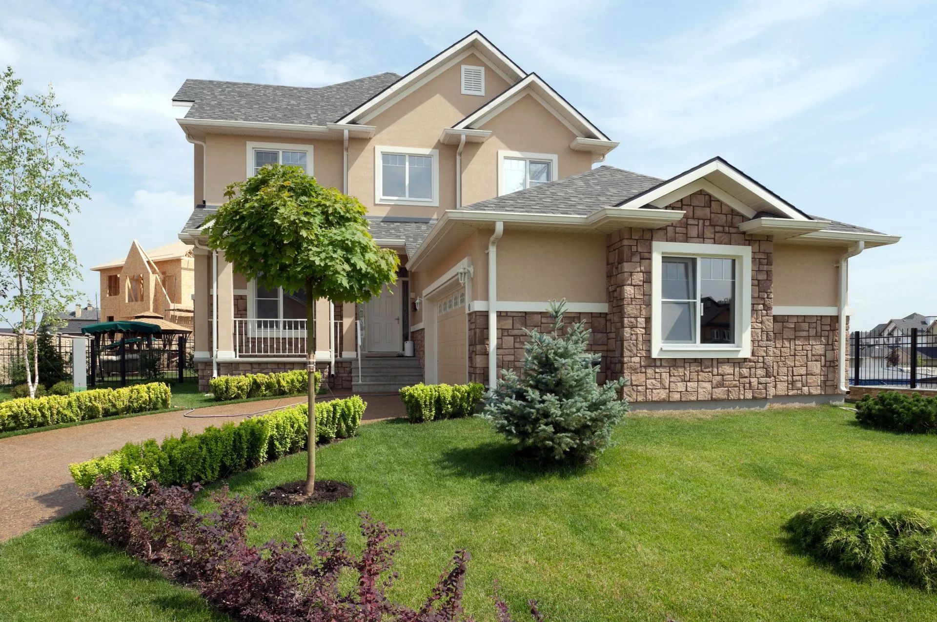 A large house with a lush green lawn in front of it.