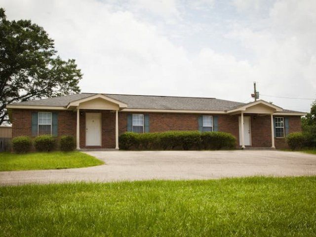 Steelman Road duplex exterior - Brick with green shutters
