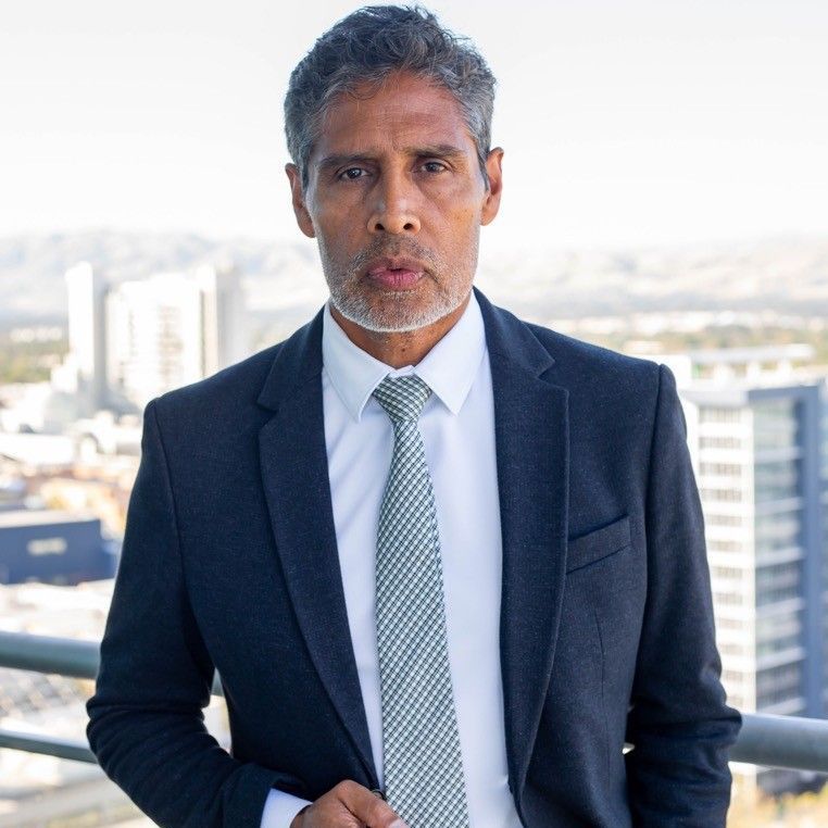 A man in a suit and tie is standing on a balcony