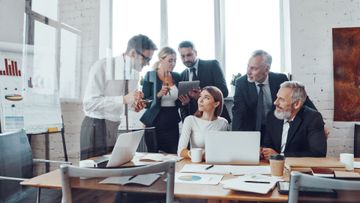 A group of business people are having a meeting in an office.