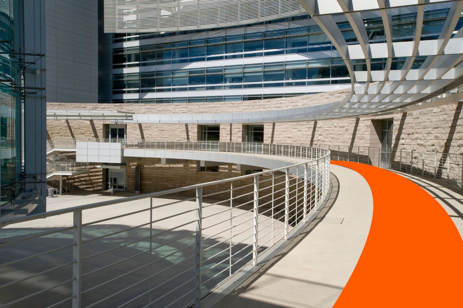 A bridge leading to a building with a red line going through it.
