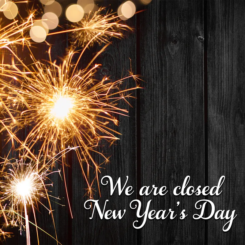 Sparklers on black wood background, text: 