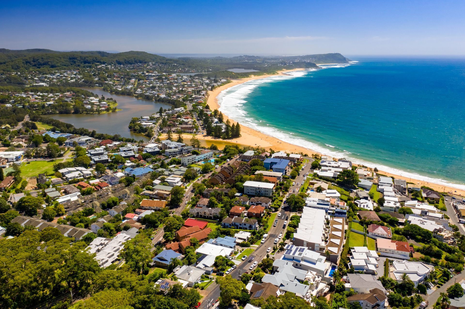 An Aerial View Of A Residential Area Next To A Beach — Coastline Air In Terrigal, NSW