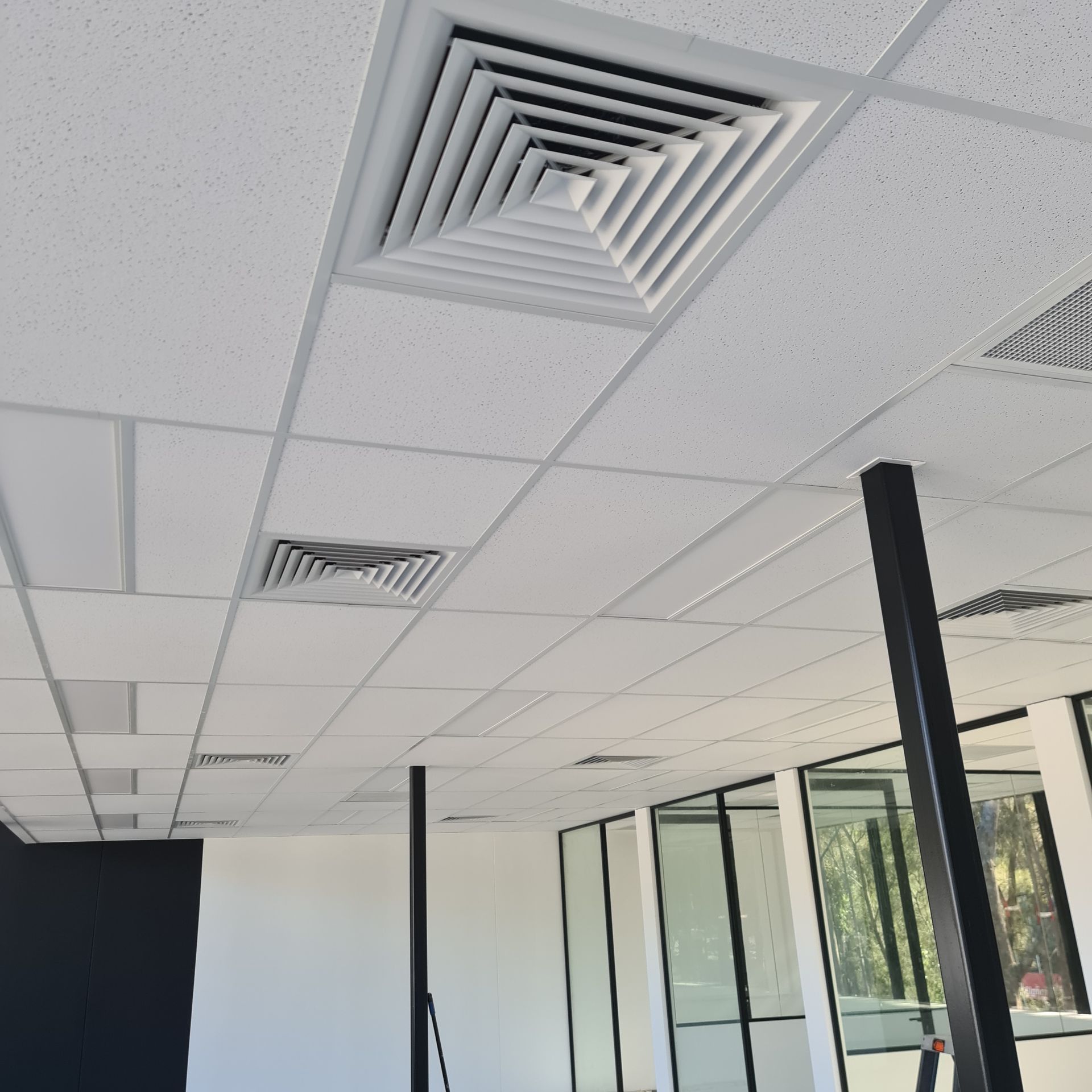 A room with a ceiling that has square vents on it — Coastline Air In Forresters Beach, NSW