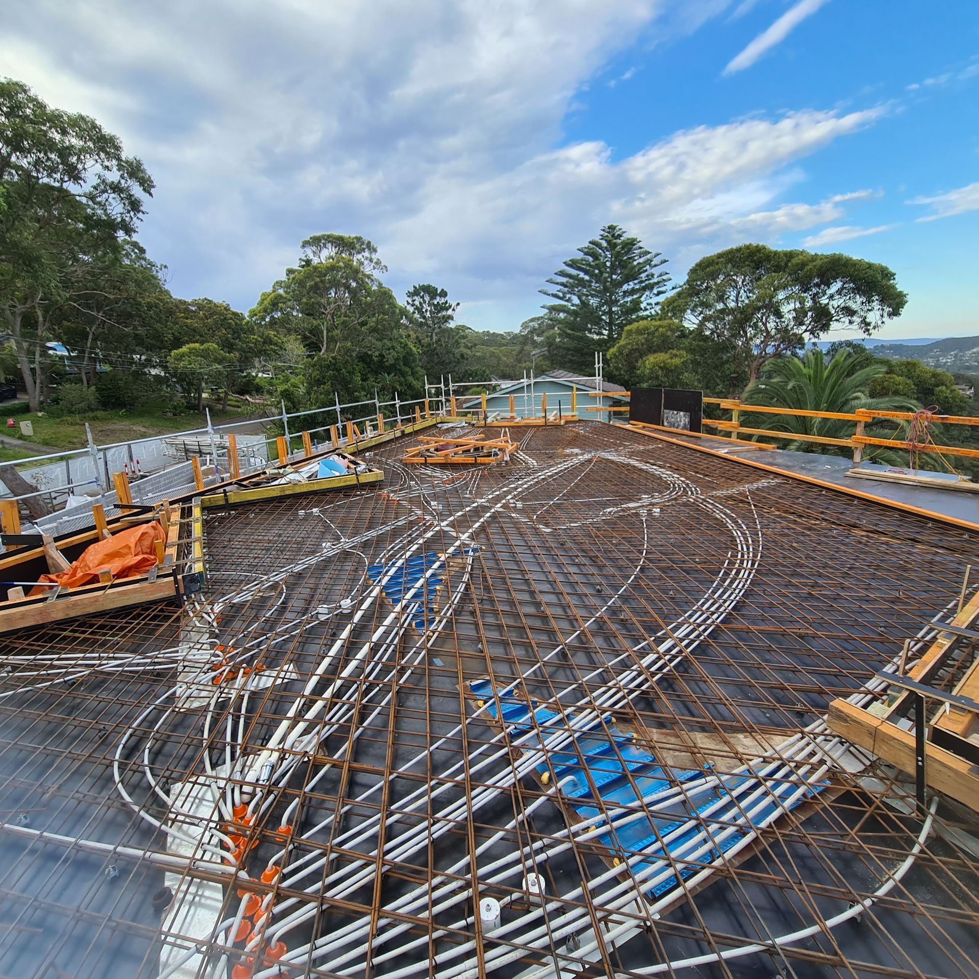 A construction site with a lot of wires laying on the ground — Coastline Air In Forresters Beach, NSW