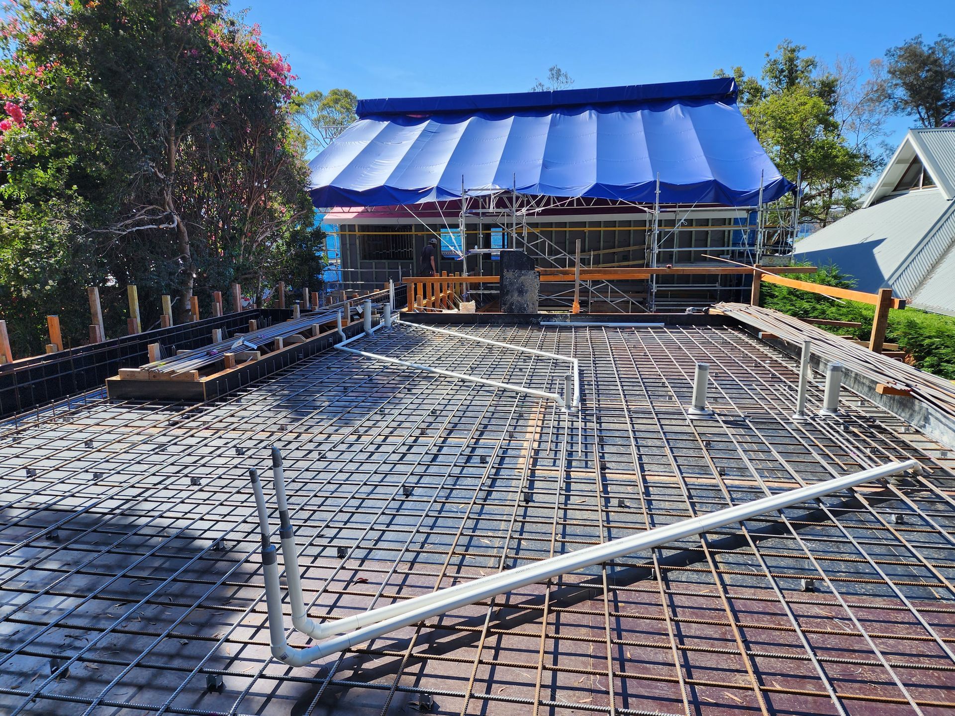 A building under construction with a blue tarp on the roof. — Coastline Air In Forresters Beach, NSW