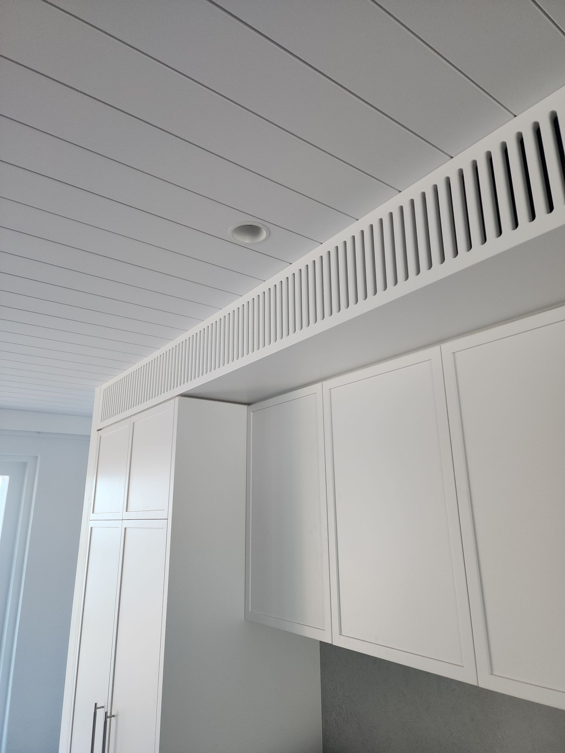 A kitchen with white cabinets and a white ceiling — Coastline Air In Forresters Beach, NSW