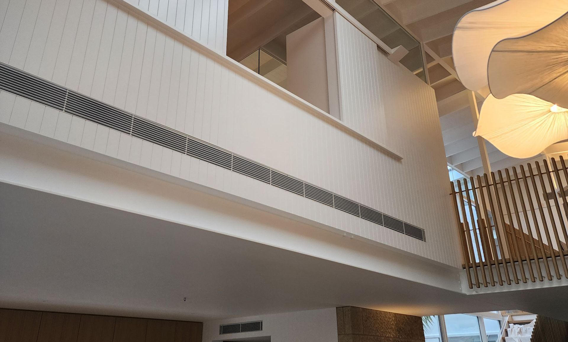 A room with a balcony and a ceiling light — Coastline Air In Forresters Beach, NSW