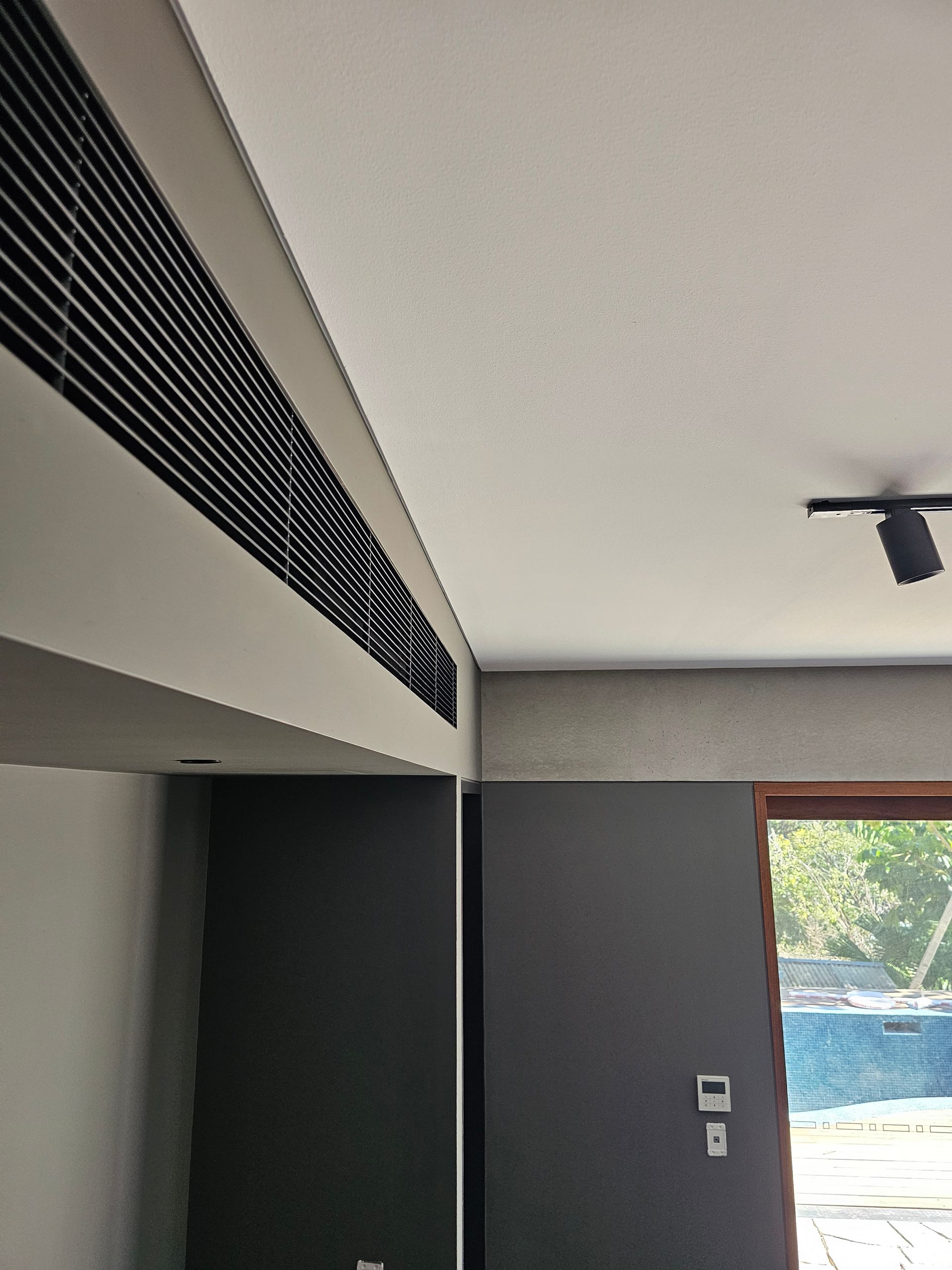 A room with a white ceiling and black walls — Coastline Air In Forresters Beach, NSW