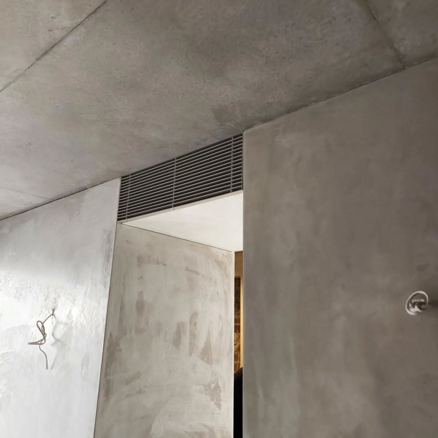 A room with a concrete wall and a ceiling — Coastline Air In Forresters Beach, NSW