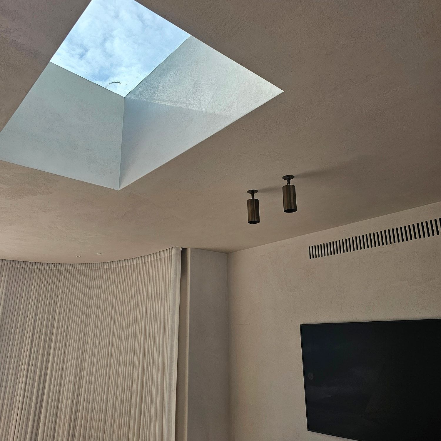 A room with a skylight in the ceiling — Coastline Air In Forresters Beach, NSW