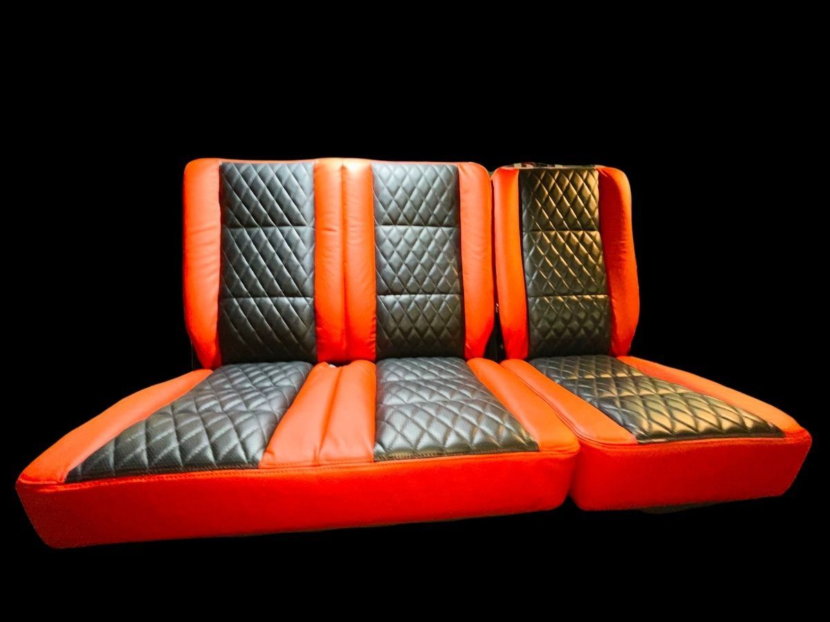 Red and black car seats with diamond-stitched black centers.