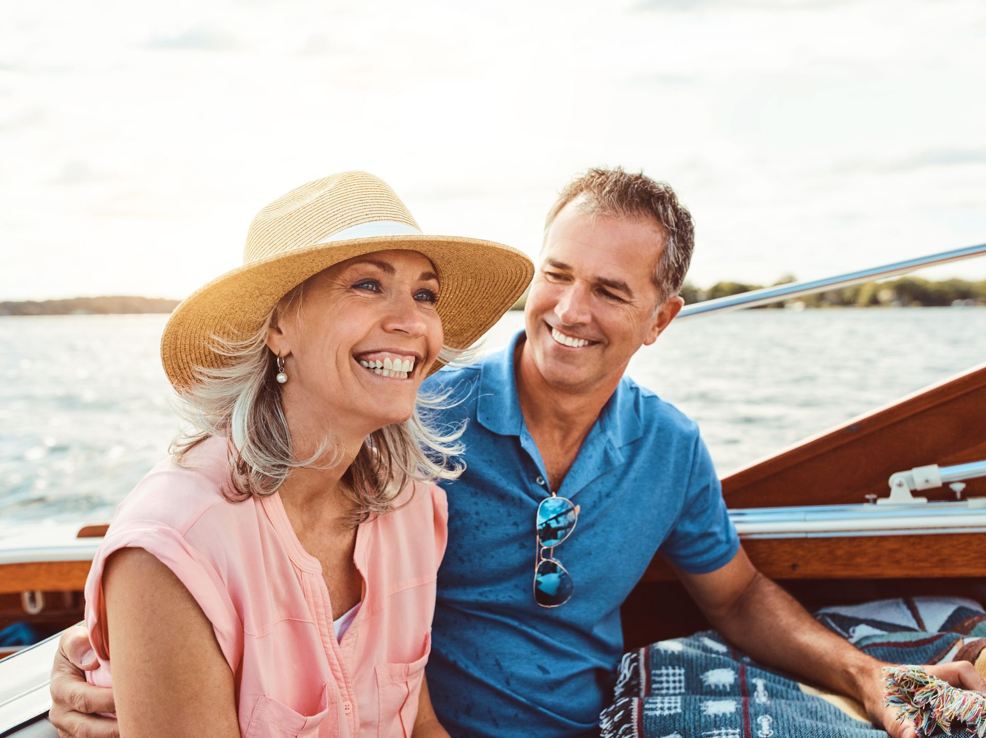 A man and a woman are sitting in a boat on a lake.