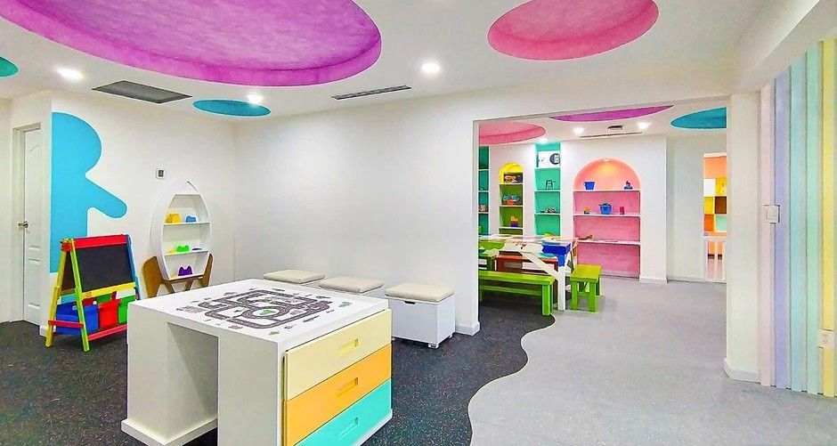 A colorful children 's room with a table and chairs.