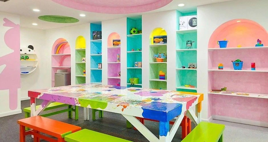 A room with a long table and benches in it.