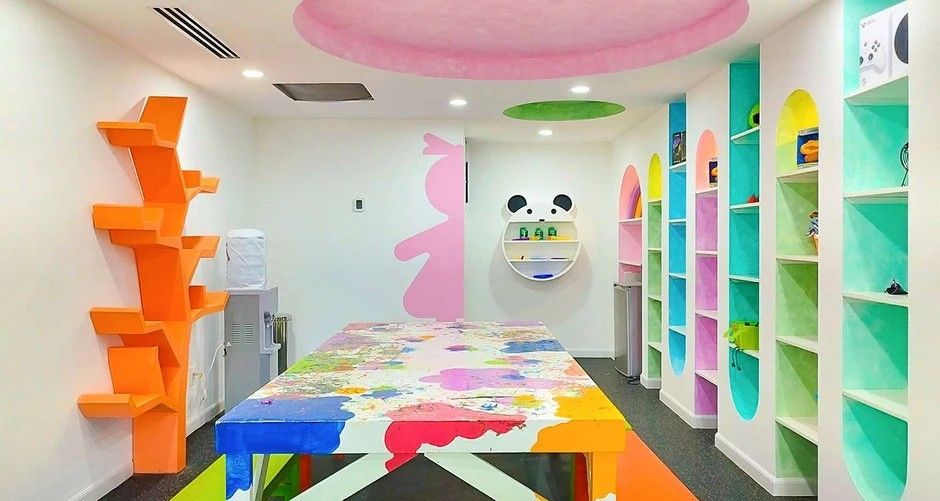 A room with a table and shelves painted in different colors.