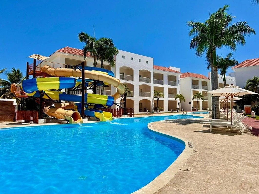 There is a water slide in the middle of the pool.