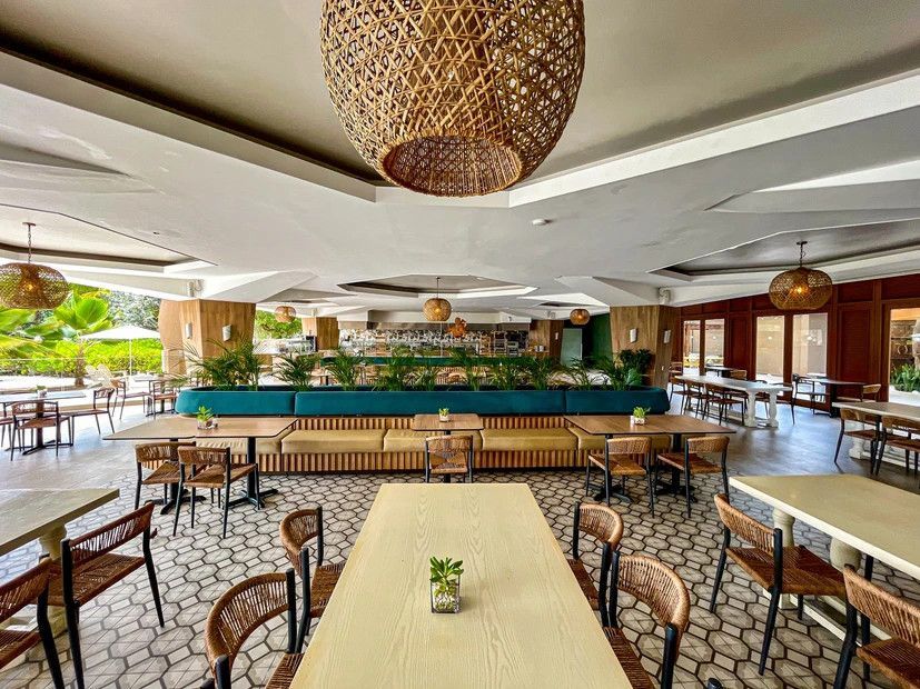 There are many tables and chairs in the restaurant.