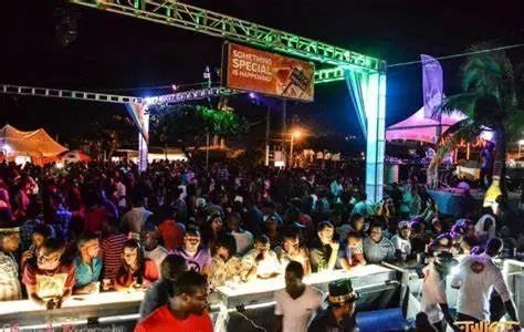 A crowd of people at a party with a sign that says southern special