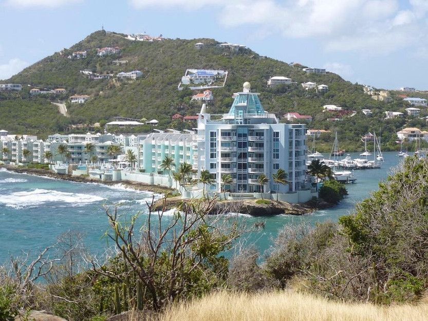 A large building on a hill overlooking a body of water