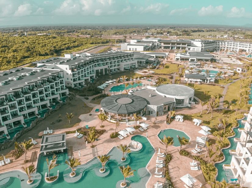 An aerial view of a large resort with lots of pools and buildings.