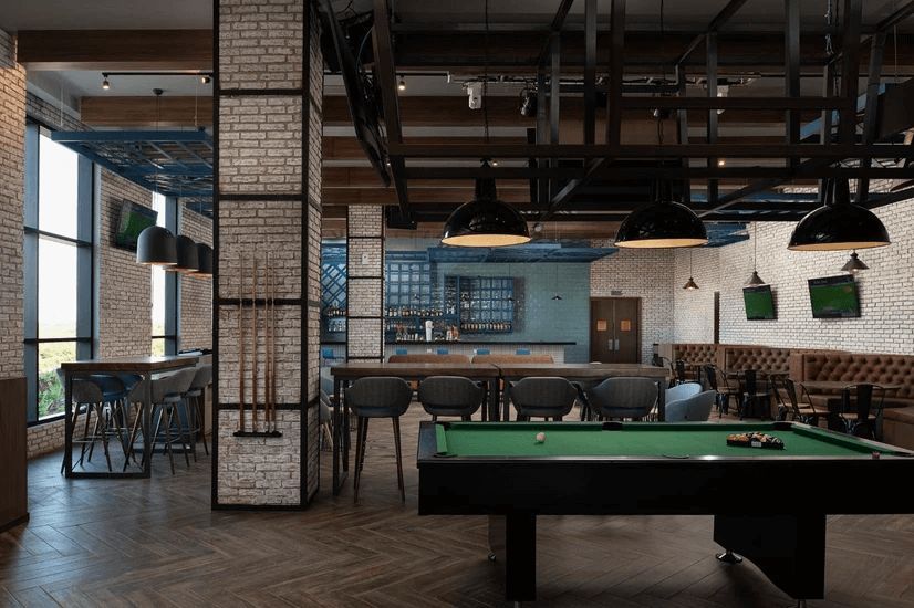 There is a pool table in the middle of the room.