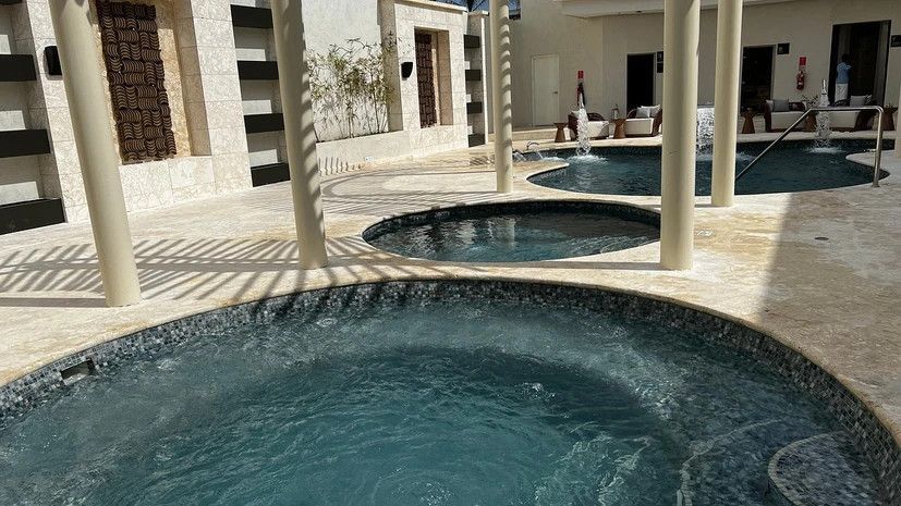 There are two hot tubs in the middle of a pool.