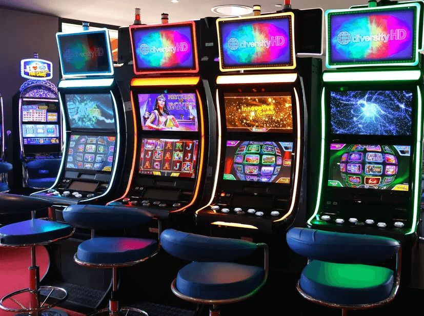 A row of slot machines are lined up in a casino