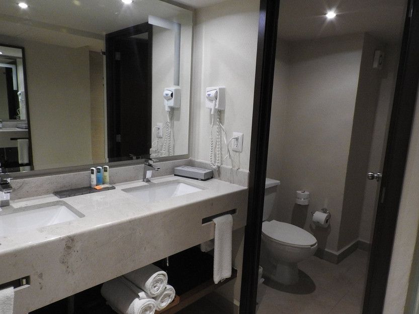 A bathroom with a sink , toilet and mirror