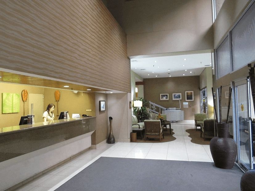 A woman at a counter in a hotel lobby