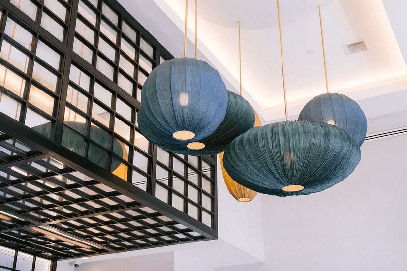 A group of lanterns hanging from the ceiling of a room.