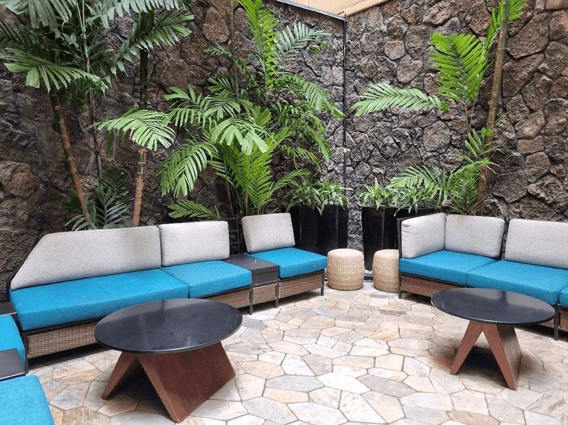 A patio with a lot of furniture and tables.