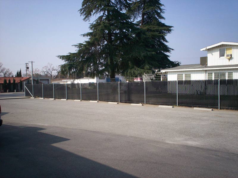 Big house with chainlink fence — Wood Fences in Bakersfield, CA