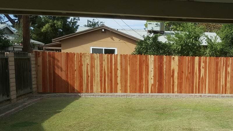 Fences in grass— Wood Fences in Bakersfield, CA