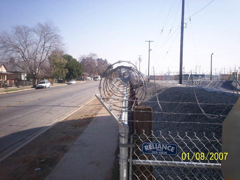 Chainlink fence with barb wire — Wood Fences in Bakersfield, CA