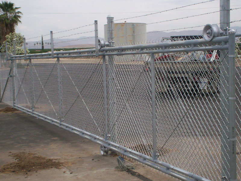 Chainlink gate with barb wire — Wood Fences in Bakersfield, CA