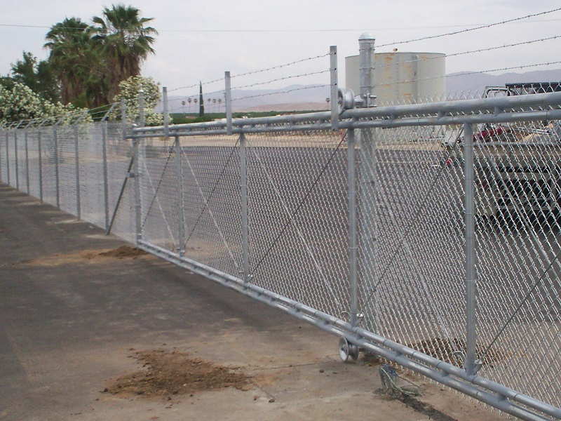 Chainlink gate with barb wire side view — Wood Fences in Bakersfield, CA