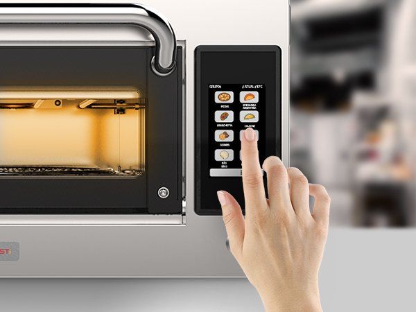 A person is pressing a button on a microwave oven