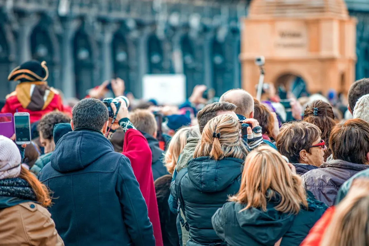 Crowded tourists in a historic European city centre, illustrating overtourism
