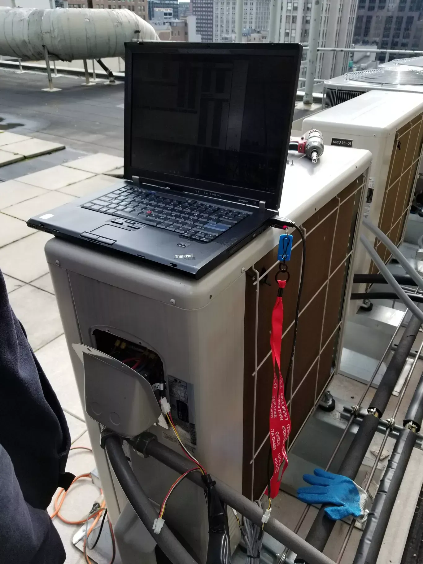 A laptop computer is sitting on top of a machine.