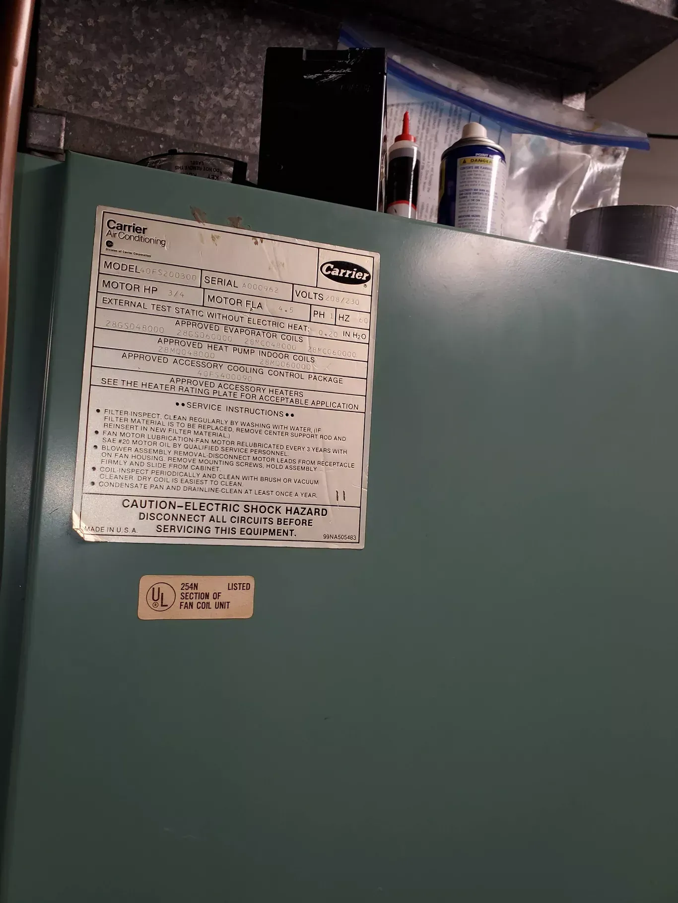 A green refrigerator with a white sticker on it