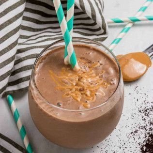 Chocolate peanut butter smoothie in a glass with striped straws.