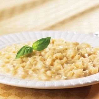 Pasta dish with creamy sauce and basil garnish on a white plate.