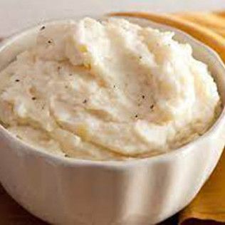 Bowl of creamy, white mashed potatoes.