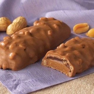 Chocolate candy bar with peanuts, cut to show peanut butter filling.