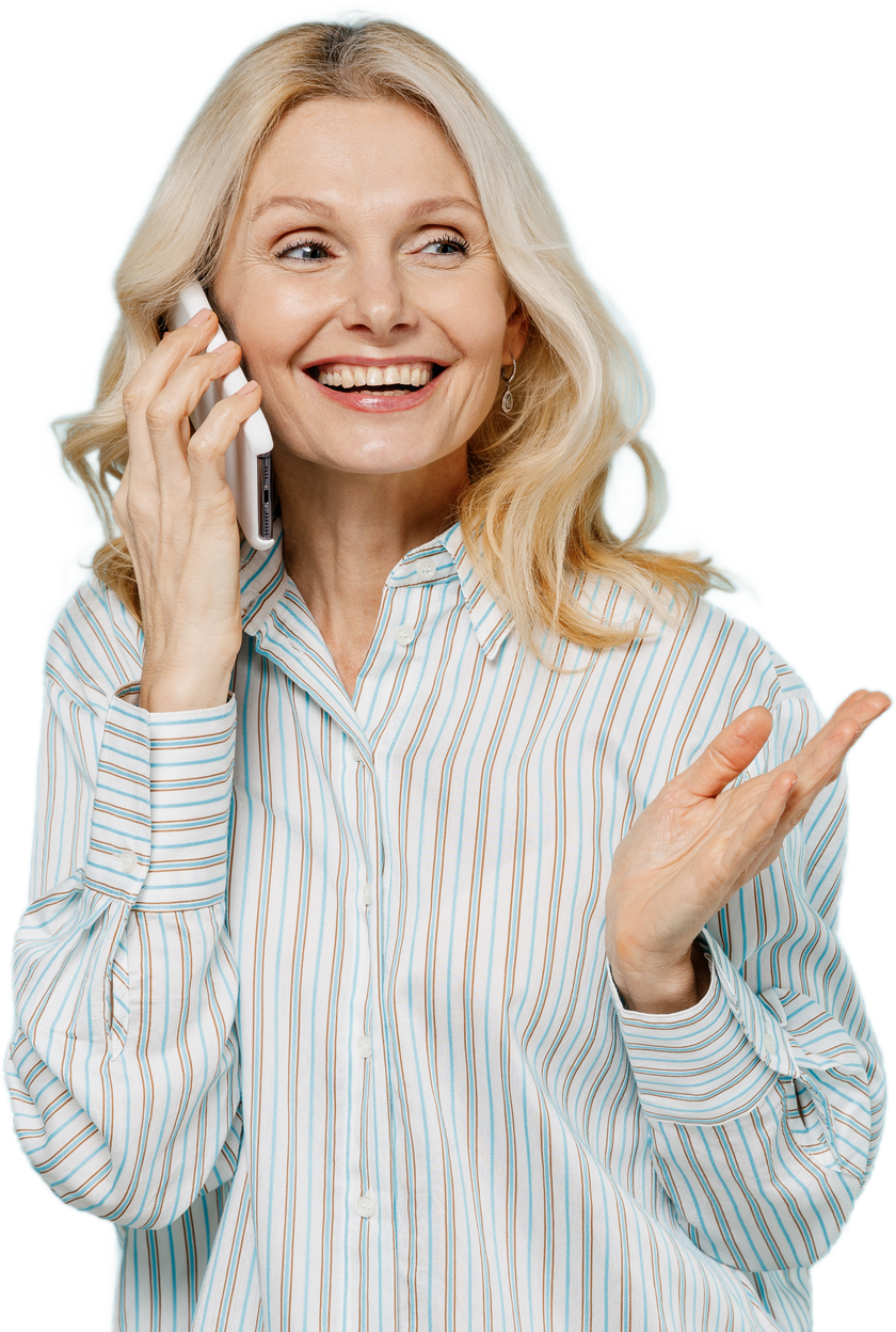 Blonde woman in striped shirt smiles and gestures while talking on a cell phone.