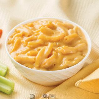 Bowl of creamy macaroni and cheese; yellow-orange sauce over elbow pasta.
